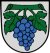 Das Wappen von Grunern: eine blaue Weintraube auf grauem Schild