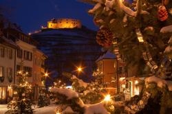 Weihnachtlich geschmückte Staufener Altstadt mit der beleuchteten Burg im Hintergrund
